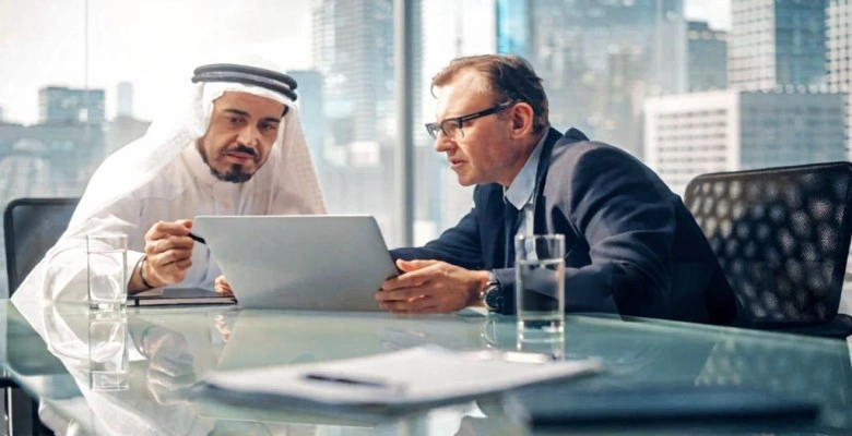 Business professionals discussing ISO consultancy strategies and certification planning in UAE office