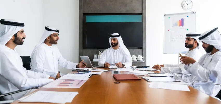 UAE management team reviewing internal audit findings during an ISO compliance meeting
