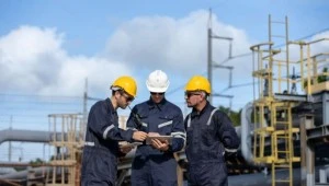 Engineers reviewing industrial operations for environmental compliance and ISO 14001 implementation