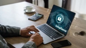 Laptop showing compliance and security icon, representing ISO 27001 access control evidence for UAE audits