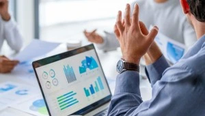 SME team reviewing ISO 9001 quality performance charts and business data in a UAE office meeting