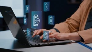 Professional reviewing digital compliance documents and ISO audit checklist using laptop in office environment