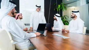 UAE management team discussing internal audit findings and compliance issues during an ISO review meeting